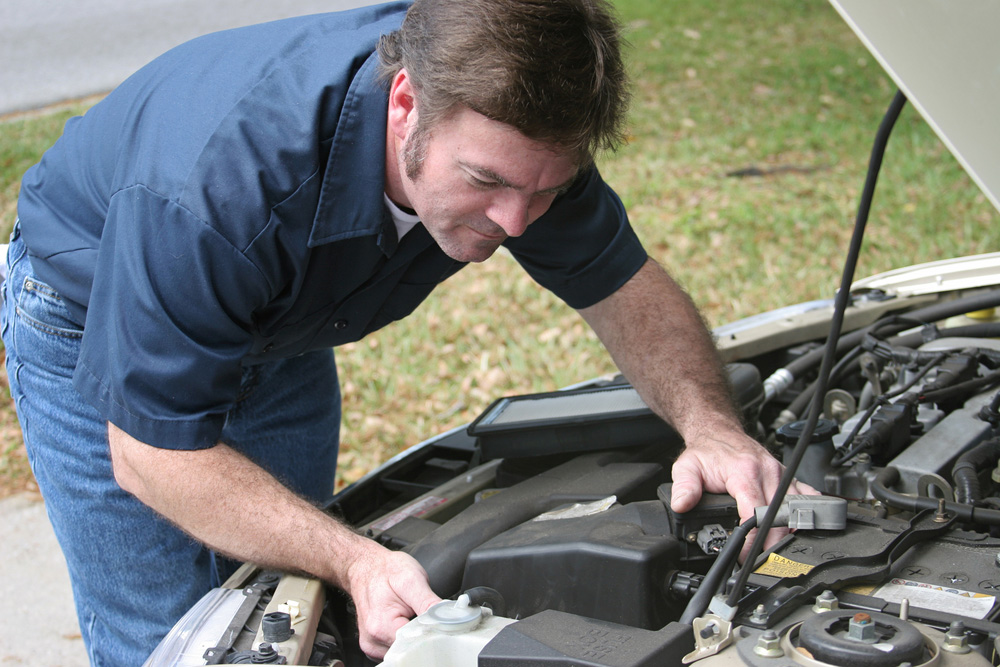 Walter Jay Collision Center technician refinishing a vehicle